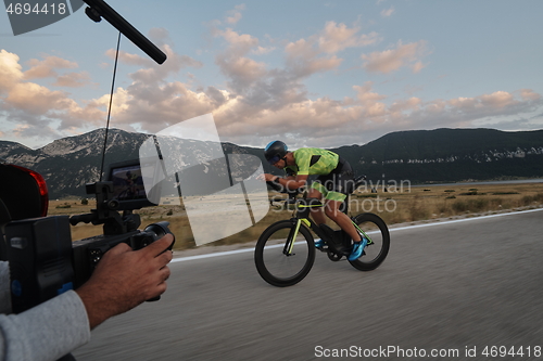 Image of cinematographer taking action shot of triathlon bike athlete