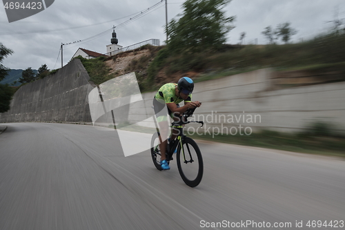 Image of triathlon athlete riding a bike on morning training