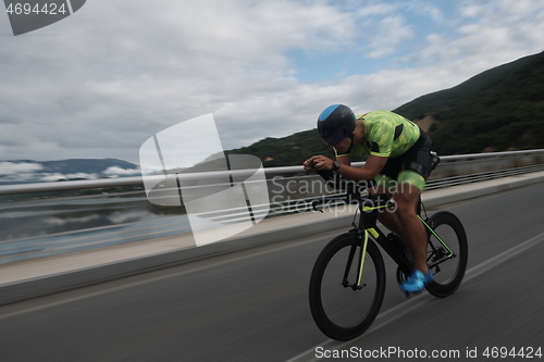 Image of triathlon athlete riding a bike on morning training