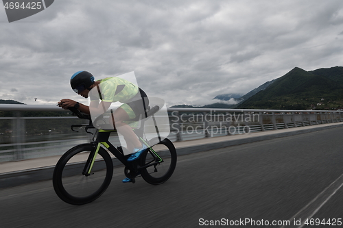 Image of triathlon athlete riding a bike on morning training