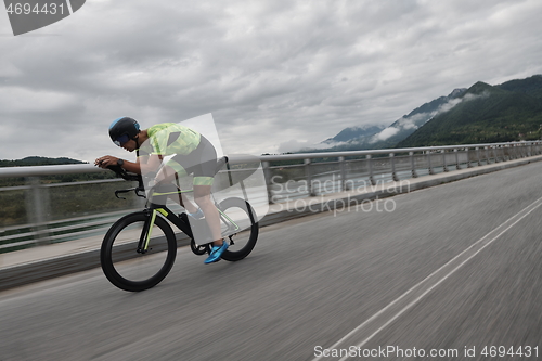 Image of triathlon athlete riding a bike on morning training