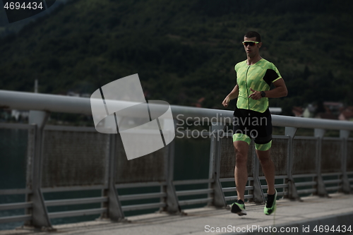 Image of triathlon athlete running on street