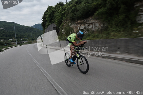 Image of triathlon athlete riding a bike on morning training