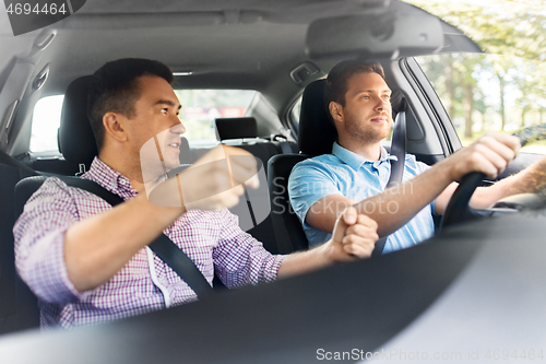 Image of car driving school instructor teaching male driver