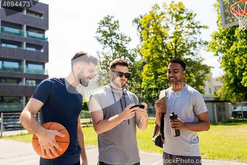 Image of men with smartphone at basketball playground