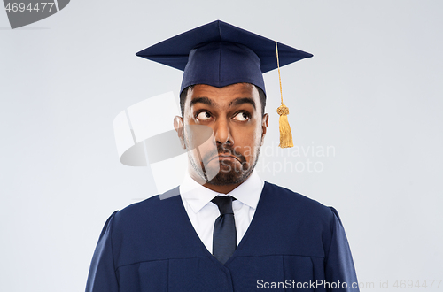 Image of confused indian graduate student in mortar board