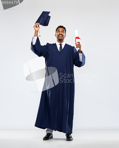 Image of male graduate student in mortar board with diploma