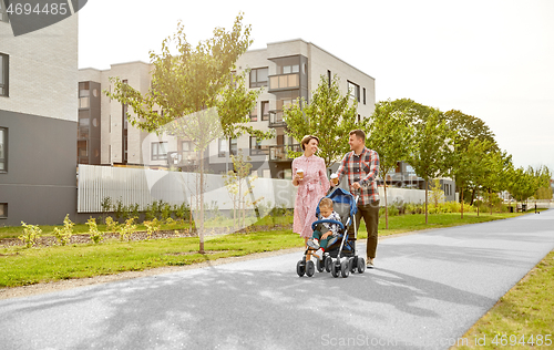 Image of family with baby in stroller and coffee in city