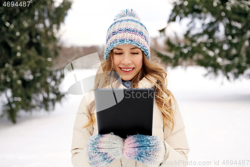 Image of woman with tablet computer outdoors in winter