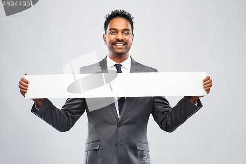 Image of smiling indian businessman with white banner