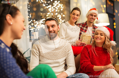 Image of friends celebrating christmas at home party