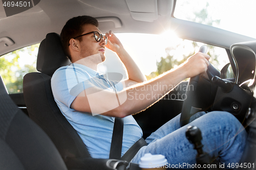 Image of man or driver in glasses driving car in summer