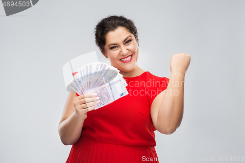 Image of happy woman holding thousands of money banknotes