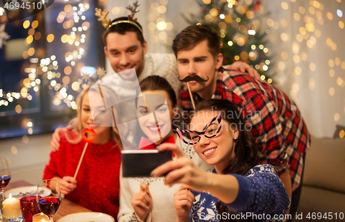 Image of friends taking selfie at christmas dinner