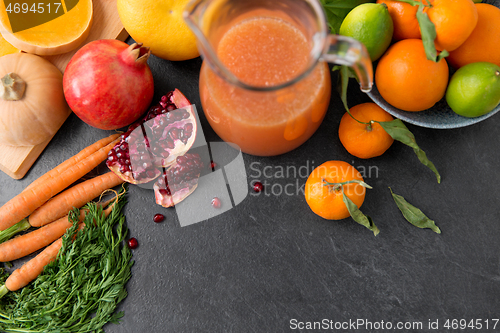 Image of glass jug of juice with fruits and vegetables