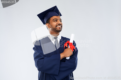 Image of male graduate student in mortar board with diploma