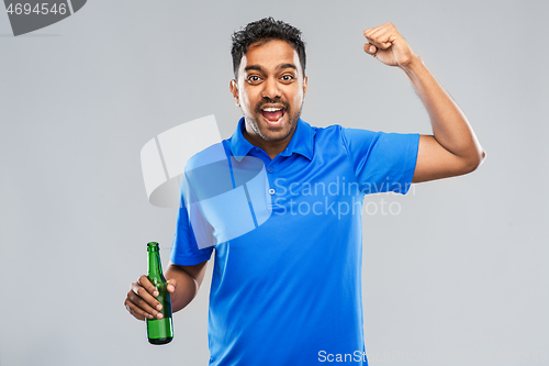 Image of male fan with beer bottle celebrating victory