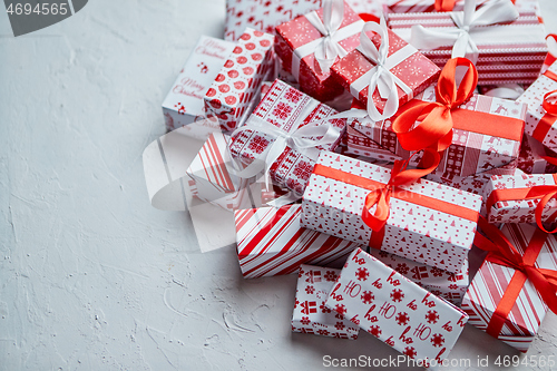 Image of A pile various size wrapped in festive paper boxed gifts placed on stack. Christmas concept