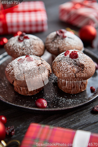 Image of Christmas chocolate delicious muffins served on black ceramic plate