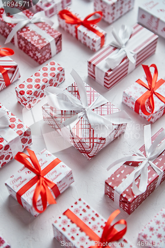 Image of Colorful white and red Christmas theme. Wrapped gifts in festive paper with ribbon