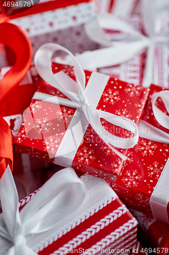 Image of Christmas concept. Close up on festive paper wrapped gifts with ribbon