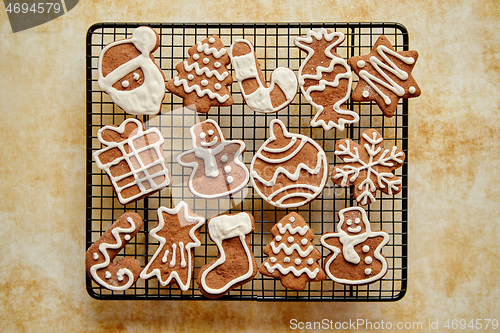 Image of Fresh baked Christmas shaped gingerbread cookies placed on steel grill