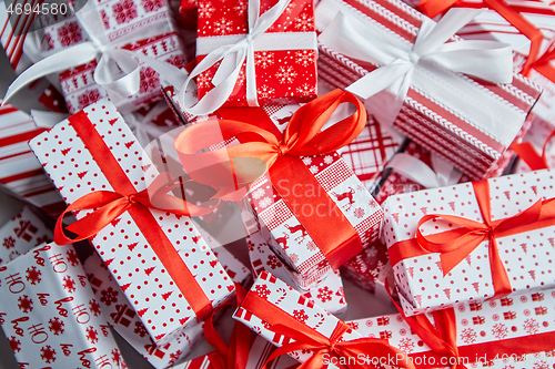 Image of Christmas concept. Close up on festive paper wrapped gifts with ribbon