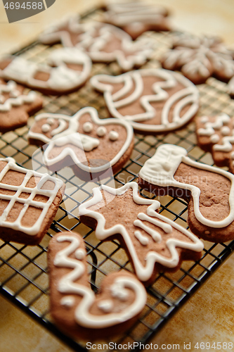 Image of Fresh baked Christmas shaped gingerbread cookies placed on steel grill