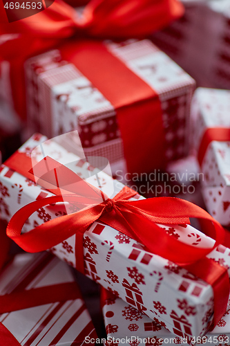 Image of Christmas concept. Close up on festive paper wrapped gifts with ribbon
