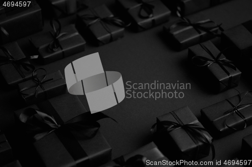 Image of Arranged Gifts boxes wrapped in black paper with black ribbon on