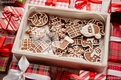 Image of Delicious fresh Christmas decorated gingerbread cookies placed in wooden crate