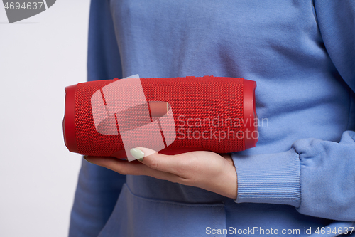 Image of Woman hand holding portable stereo speaker