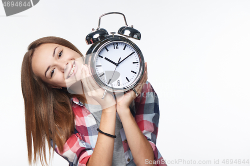 Image of Portrait of smiling teen girl holding big clock