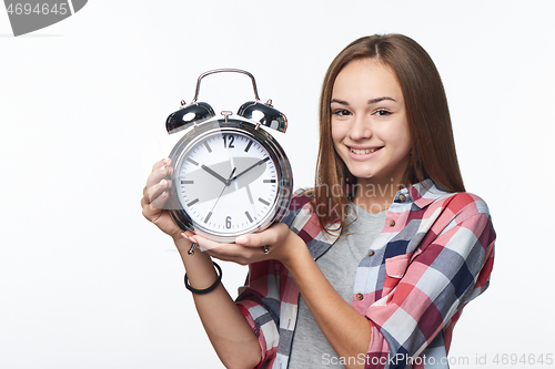 Image of Portrait of smiling teen girl holding big clock