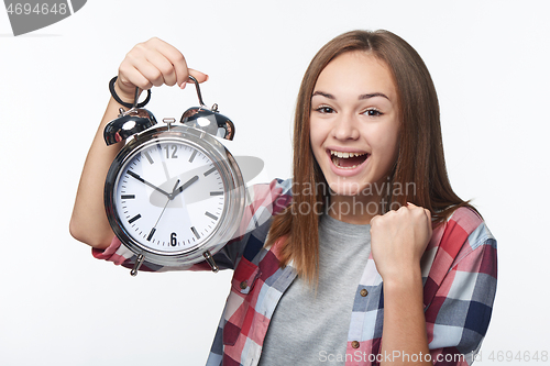 Image of Portrait of smiling teen girl holding big clock