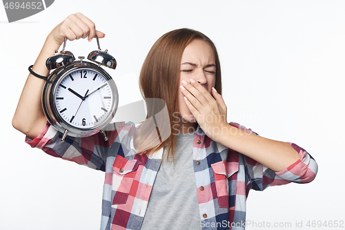 Image of Portrait of smiling teen girl holding big clock