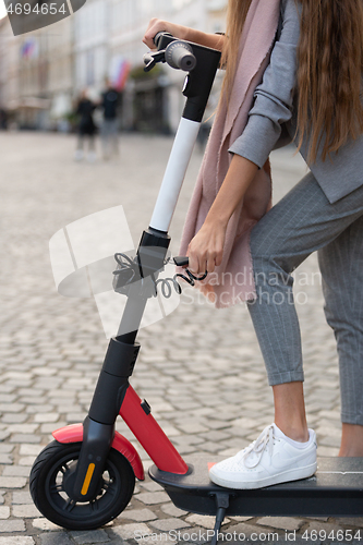 Image of User unlocking rental electric scooter. Eco friendly green modern urban mobility concept of sharing transportation with electric scooters for rent in Ljubljana, Slovenia