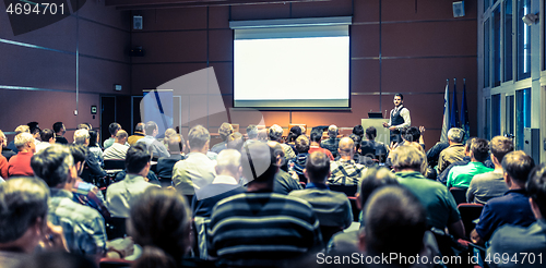 Image of Business speaker giving a talk at business conference meeting event.