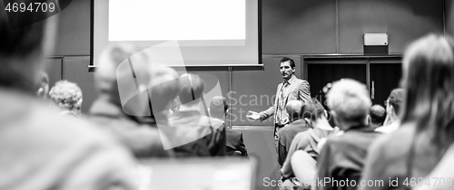 Image of Business speaker giving a talk at business conference meeting event.