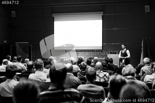 Image of Speaker giving presentation on business conference event.