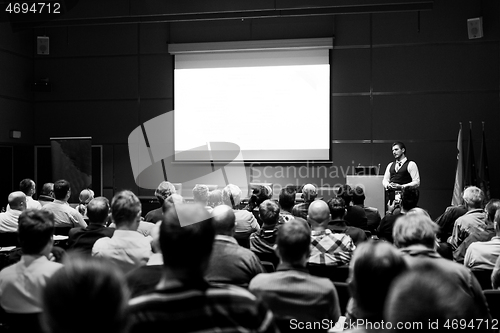 Image of Speaker giving presentation on business conference event.