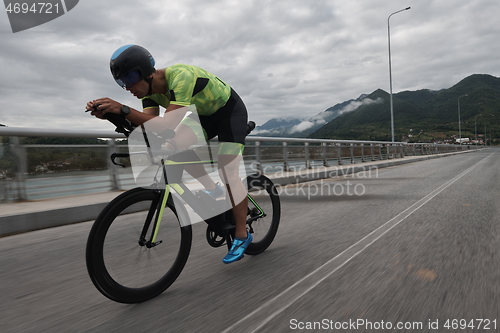 Image of triathlon athlete riding a bike on morning training