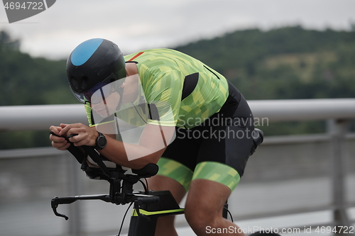 Image of triathlon athlete riding a bike on morning training