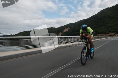 Image of triathlon athlete riding a bike on morning training