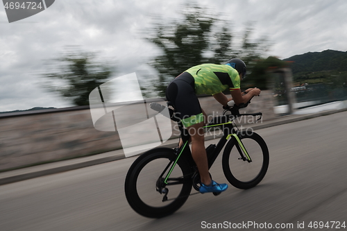 Image of triathlon athlete riding a bike on morning training