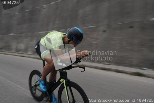 Image of triathlon athlete riding a bike on morning training