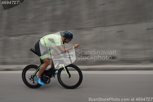 Image of triathlon athlete riding a bike on morning training