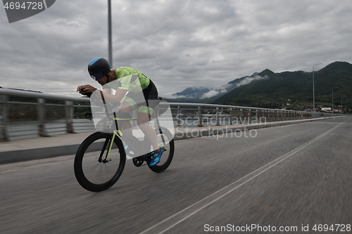 Image of triathlon athlete riding a bike on morning training