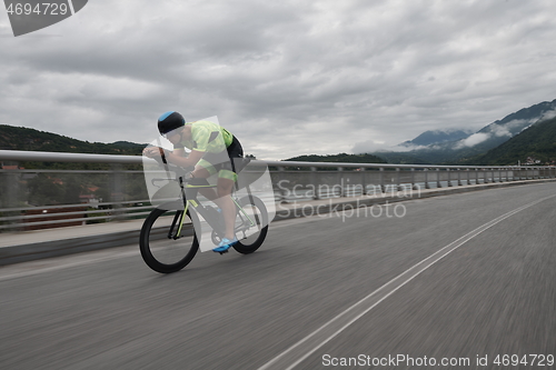 Image of triathlon athlete riding a bike on morning training