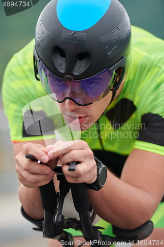 Image of triathlon athlete riding a bike on morning training